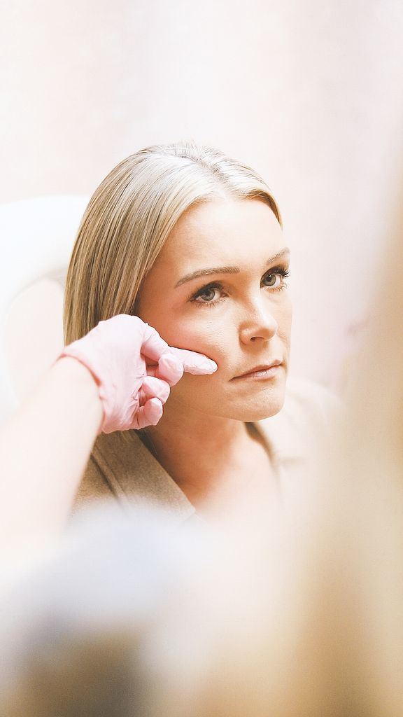 Close-up of a woman receiving a cosmetic injection at a modern beauty clinic.