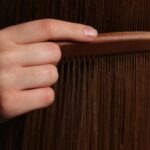 Mão a pentear cabelo longo